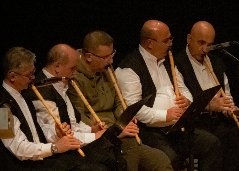 Sufi musician playing the ney during a Mevlevi ceremony